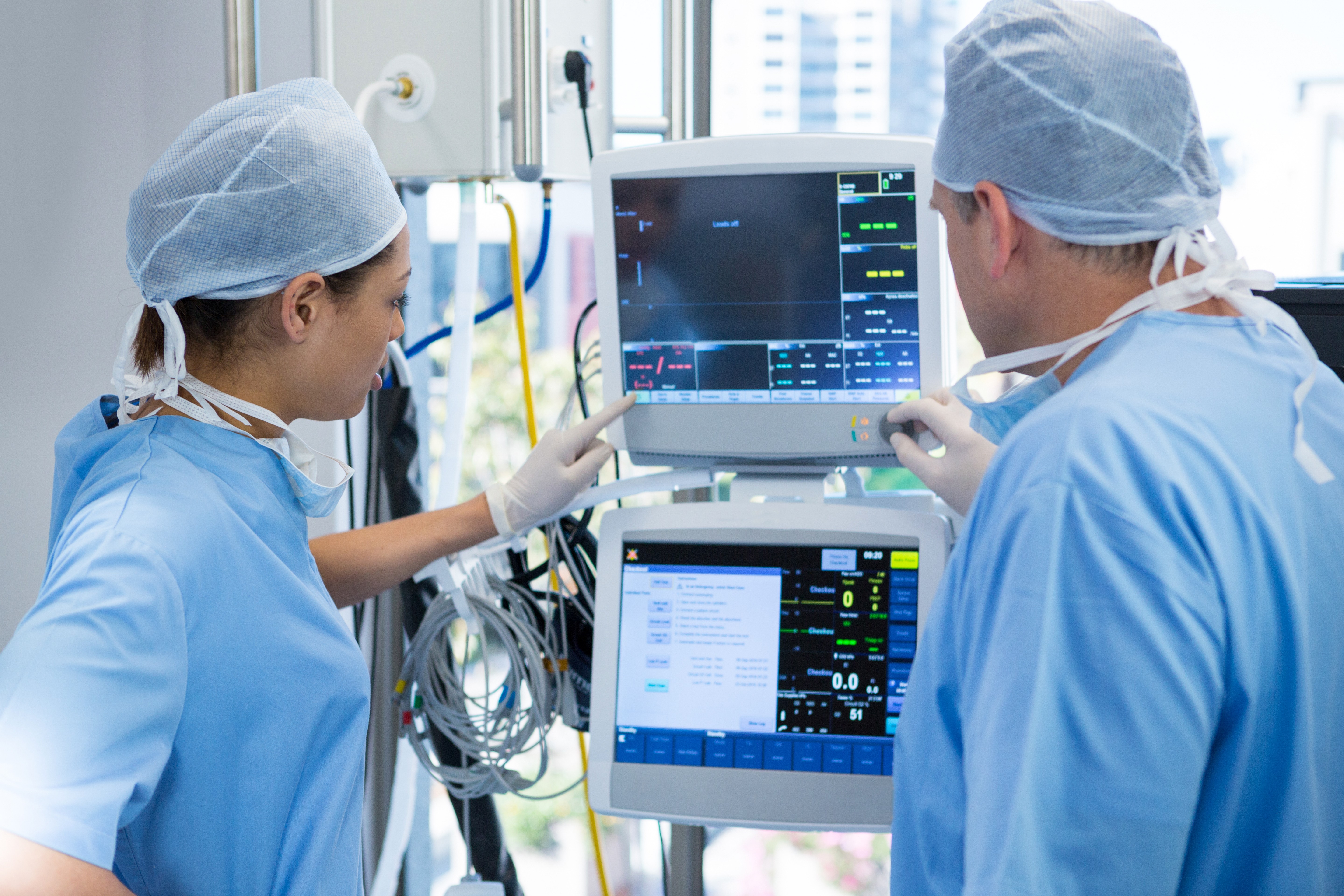Doctors looking in a medical monitor