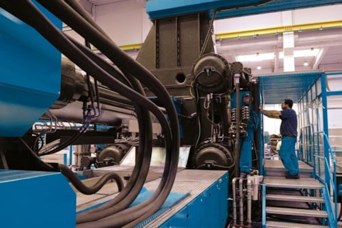 kiwa employee conducting an inspection of machinery safety in a factory