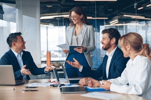 4 people in an office, having a project management meeting for wind power