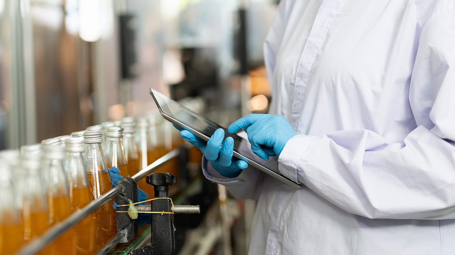 gloved inspector checking bottles