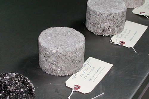 Concrete test samples at Kiwa KOAC with identification tags on a lab table, ready for analysis