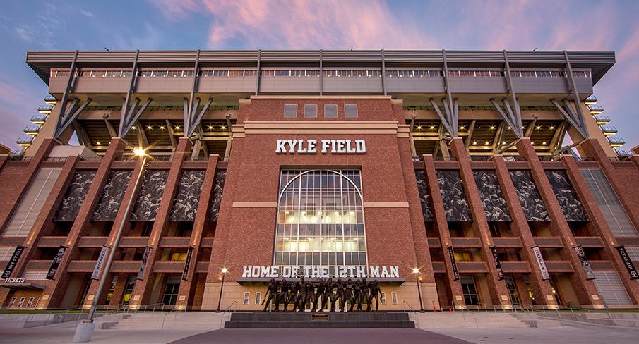 Kyle Field exterior at Texas A&M University, featuring red brick facade and iconic stadium signage at sunset